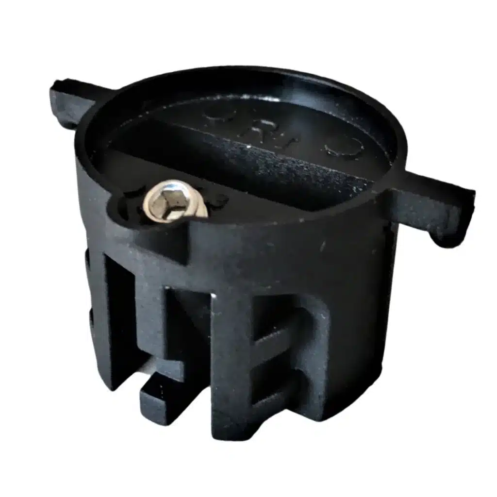 Shapers-Club- Close-up image of a black circular mechanical part, possibly a clamp or coupling, with various slots and a central clamping bolt. -surfshop-surfboard