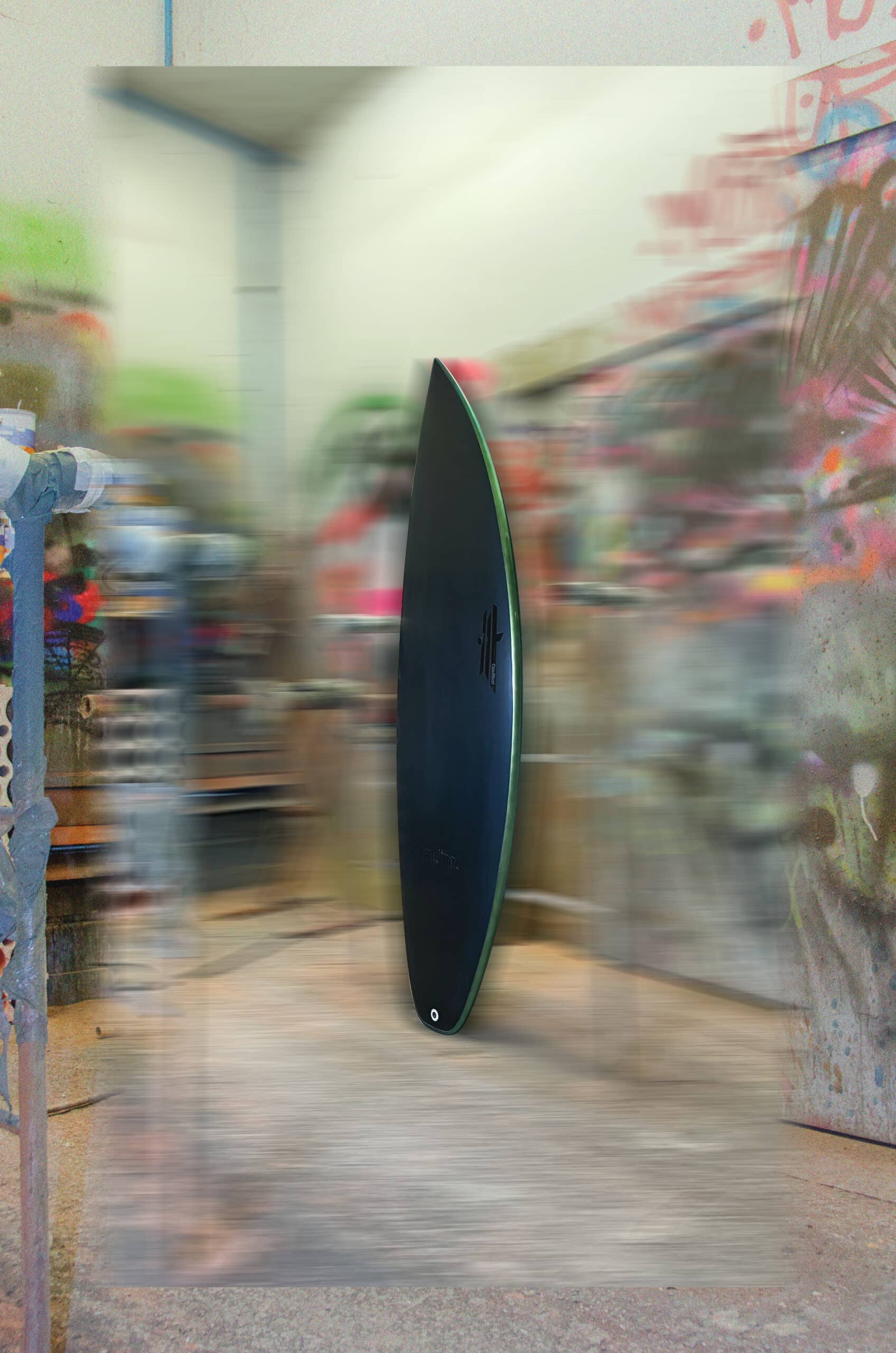 Shapers-Club- An elegant black Fire Arrow surfboard measuring 5'9" x 19' 1/4" x 2' 1/2" stands in a colorful workshop, framed by abstract graffiti and art supplies, creating a dynamic and creative atmosphere. -surfshop-surfboard